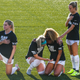 Julie Ertz prays with Casey Short. Rachel Hill is wearing blue nail polish.